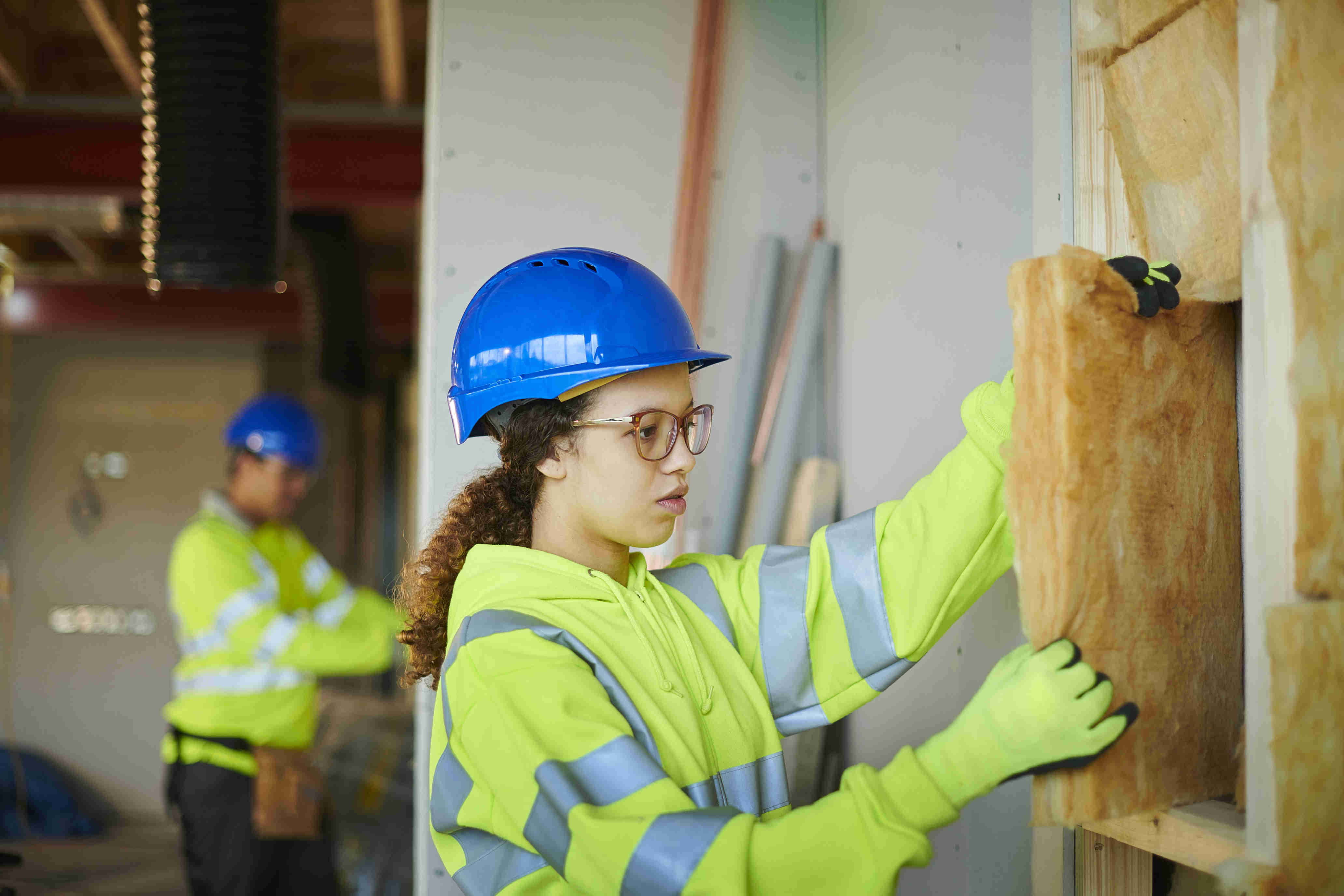 Woman Installing Wall Insulation